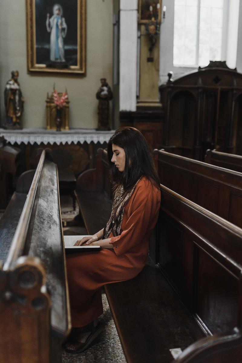 A woman prays in church.